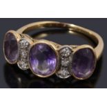 An unusual gold amethyst and diamond three stone ring