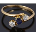 A three stone sapphire and diamond crossover ring marked 18ct