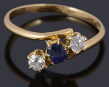 A three stone sapphire and diamond crossover ring marked 18ct