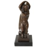 A bronze figure of a standing female nude