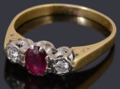 A gold ruby and diamond three stone ring