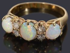 A beautiful three stone opal and diamond ring