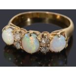 A beautiful three stone opal and diamond ring