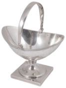 A contemporary Channel Islands silver swing handled sugar basket