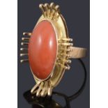 A gold single stone coral cabochon ring