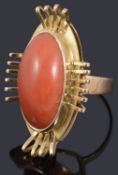 A gold single stone coral cabochon ring