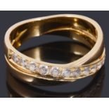 A gold coloured cubic zirconia cross over half eternity ring