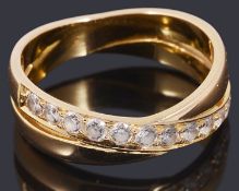 A gold coloured cubic zirconia cross over half eternity ring