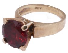 A gold single stone synthetic ruby stone ring
