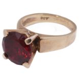 A gold single stone synthetic ruby stone ring