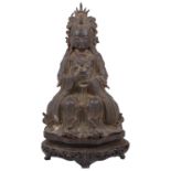 A late Ming Chinese gilt-bronze figure of Songzi Niangniang on a carved hardwood throne