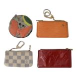 Four assorted Louis Vuitton coin purses