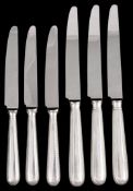 A set of thirteen silver handled Feather Edge pattern table and dessert knives