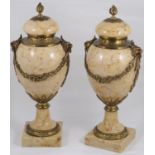 A pair of late 19th century French Louis XVI style ormolu mounted marble urns and covers