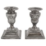 A pair of late Victorian silver neo-classical design Adam style dwarf candlesticks