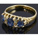 An early Edwardian 18ct gold sapphire and diamond three stone ring