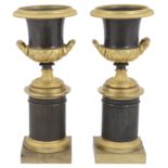 A pair of early 19th century French Empire style bronze and ormolu mounted campana urns c.1830