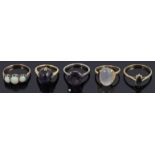 Four assorted gold gem set rings and another