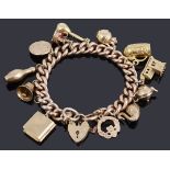 A 9ct gold hollow curb link bracelet with padlock and twelve assorted charms