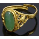 A high carat gold single stone green cabochon ring,