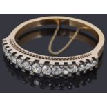 An attractive late 19th Century Swiss 18ct gold diamond hinge bangle