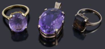 A single stone amethyst pendant and three assorted dress ring