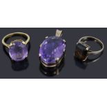 A single stone amethyst pendant and three assorted dress ring