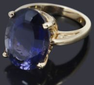 An oval cut single stone iolite ring