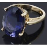 An oval cut single stone iolite ring