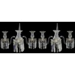A pair of late Regency cut glass three light wall appliques in the manner of Osler