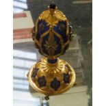 FRANKLIN MINT GILT METAL AND COBALT BLUE ENAMELLED "THE STAR OF THE NORTH" JEWELED EGG,