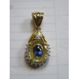18ct GOLD DROP PENDANT SET WITH CENTRAL BLUE SAPPHIRE COLOURED STONE AND SMALL DIAMONDS