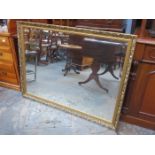 LARGE GILDED AND BEVELLED WALL MIRROR,