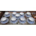 SET OF NINE ORIENTAL BLUE AND WHITE CERAMIC TEA BOWLS AND SAUCERS