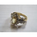 18k GOLD DRESS RING SET WITH YELLOW BERYL AND SURROUNDED BY SMALL DIAMONDS