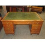 OAK NINE DRAWER PARTNER'S WRITING DESK WITH GREEN LEATHER INSERTS
