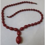 STRAND OF GRADUATED CHERRY AMBER BEADS