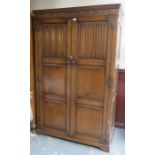 20th CENTURY OAK LINEN FOLD FRONTED TWO DOOR WARDROBE