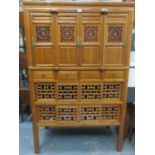 CARVED PIERCEWORK DECORATED ORIENTAL CABINET WITH FOUR DOORS TO TOP,