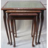 GLASS TOPPED MAHOGANY NEST OF THREE TABLES