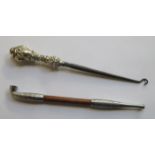 DECORATIVE SILVER COLOURED AND TURNED TREEN OPIUM PIPE AND SILVER HANDLED BUTTON HOOK.