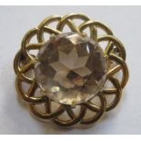 YELLOW METAL COSTUME BROOCH WITH LARGE CENTRAL STONE
