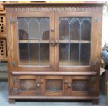 20th CENTURY PRIORY STYLE OAK TWO DOOR LEADED GLASS BOOKCASE WITH TWO DOORS BELOW