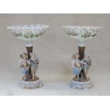 PAIR OF CONTINENTAL HANDPAINTED AND GILDED FIGURE FORM TAZZAS,