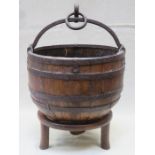 CAST IRON BOUND BARREL FORM CARRIER WITH HANDLE ON RAISED STAND,