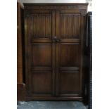 20th CENTURY OAK LINEN FOLD FRONTED TWO DOOR WARDROBE