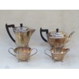 ART DECO FOUR PIECE SILVER PLATED TEA SET PLUS ONE OTHER PLATED COFFEE POT