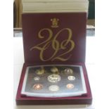 TWELVE CASED MOSTLY ROYAL MINT COIN SETS.