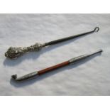 DECORATIVE SILVER COLOURED AND TURNED TREEN OPIUM PIPE AND SILVER HANDLED BUTTON HOOK.