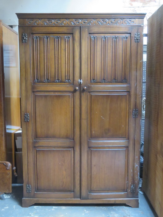 20th CENTURY OAK LINEN FOLD FRONTED TWO DOOR WARDROBE